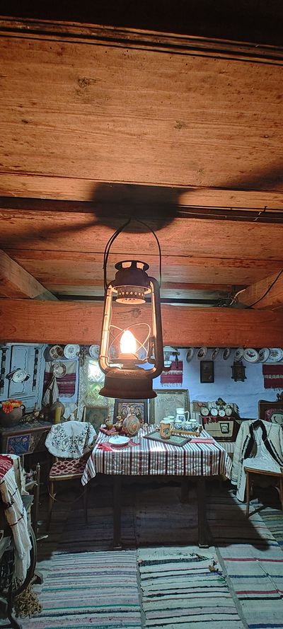 A lit oil lantern, in the house-museum