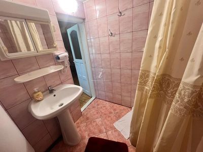 A private bathroom, with tub and shower cabin