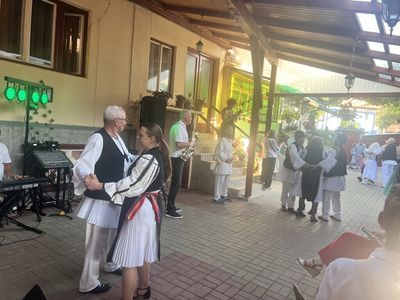 Musicians and guests dancing, at a party in the guesthouse courtyard