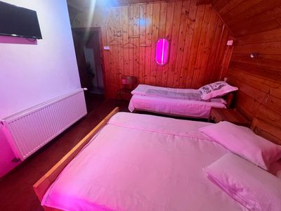 A room with a double bed and a single bed, in the attic