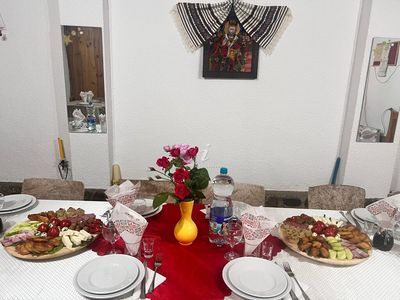 A festive table, set with platters and fresh flowers