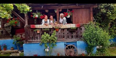 Guests on the wooden balcony, in folk costume