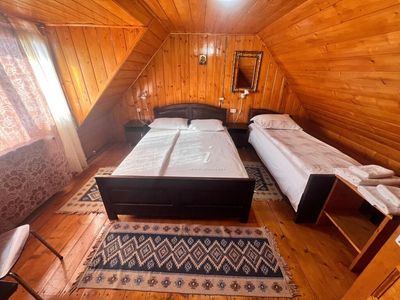 A double room, with dark wood furniture