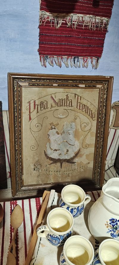 An embroidered "Holy Trinity" icon and a porcelain tea set