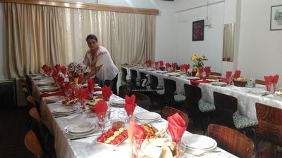 Doamna Elena, setting the table for guests