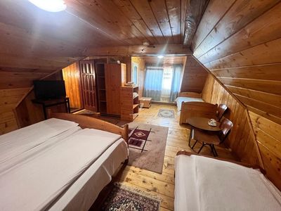 A spacious room, with a sitting area and TV